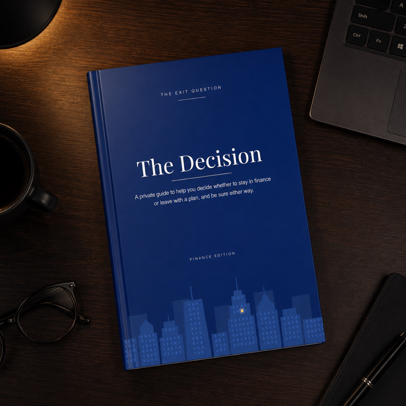 The Decision - Finance Edition hardcover resting on a desk at night